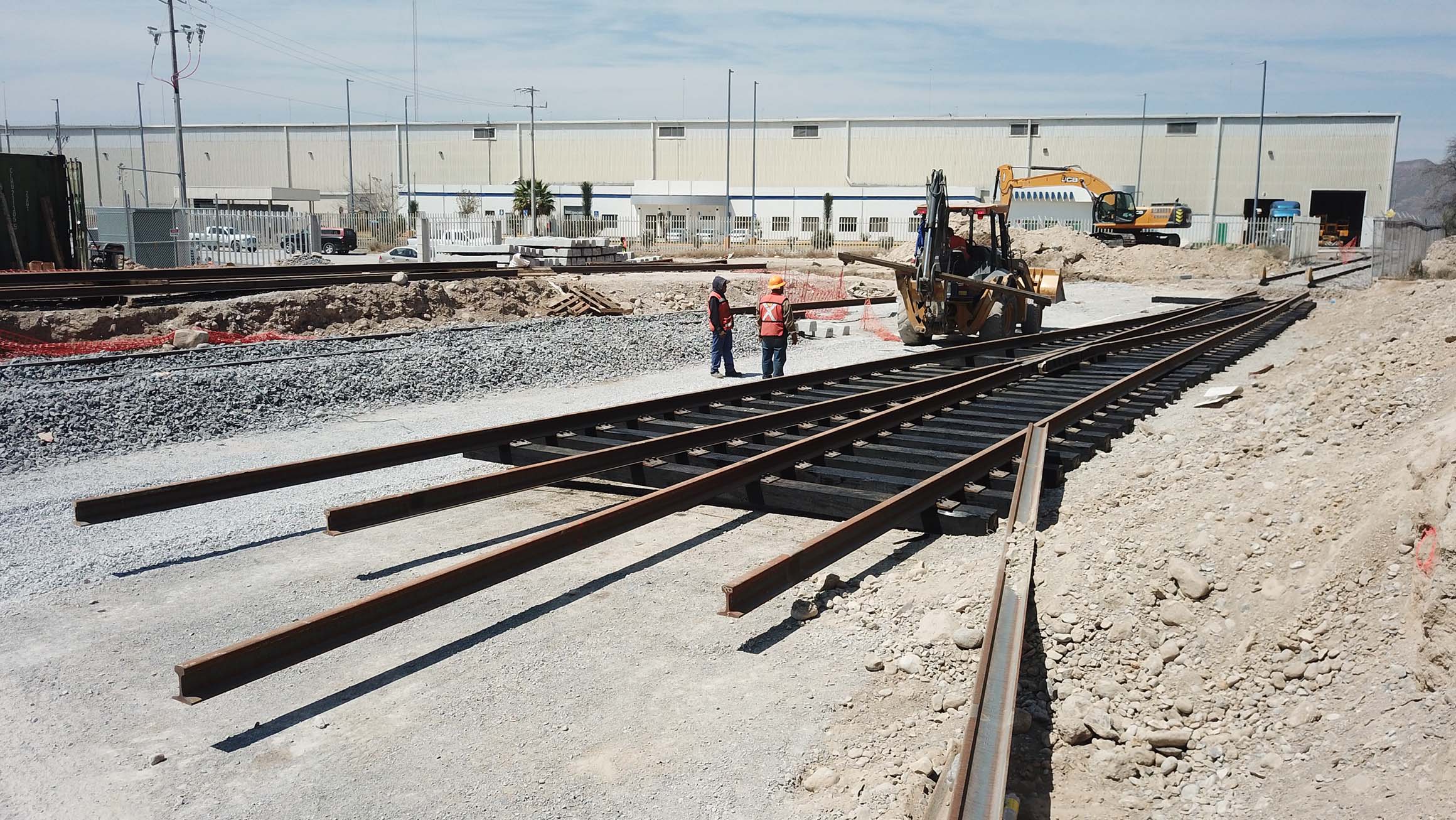 Exterior photograph of a railway system under construction for an industrial park building