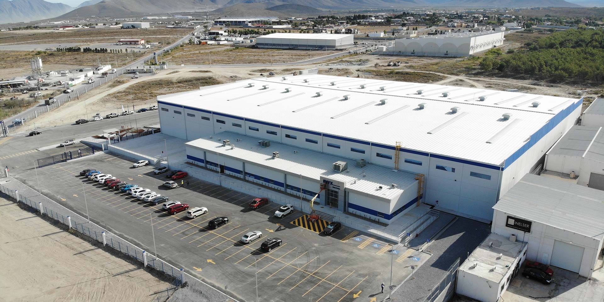 Drone photograph of a DAVISA industrial park building operated by NYX. One of our success stories.